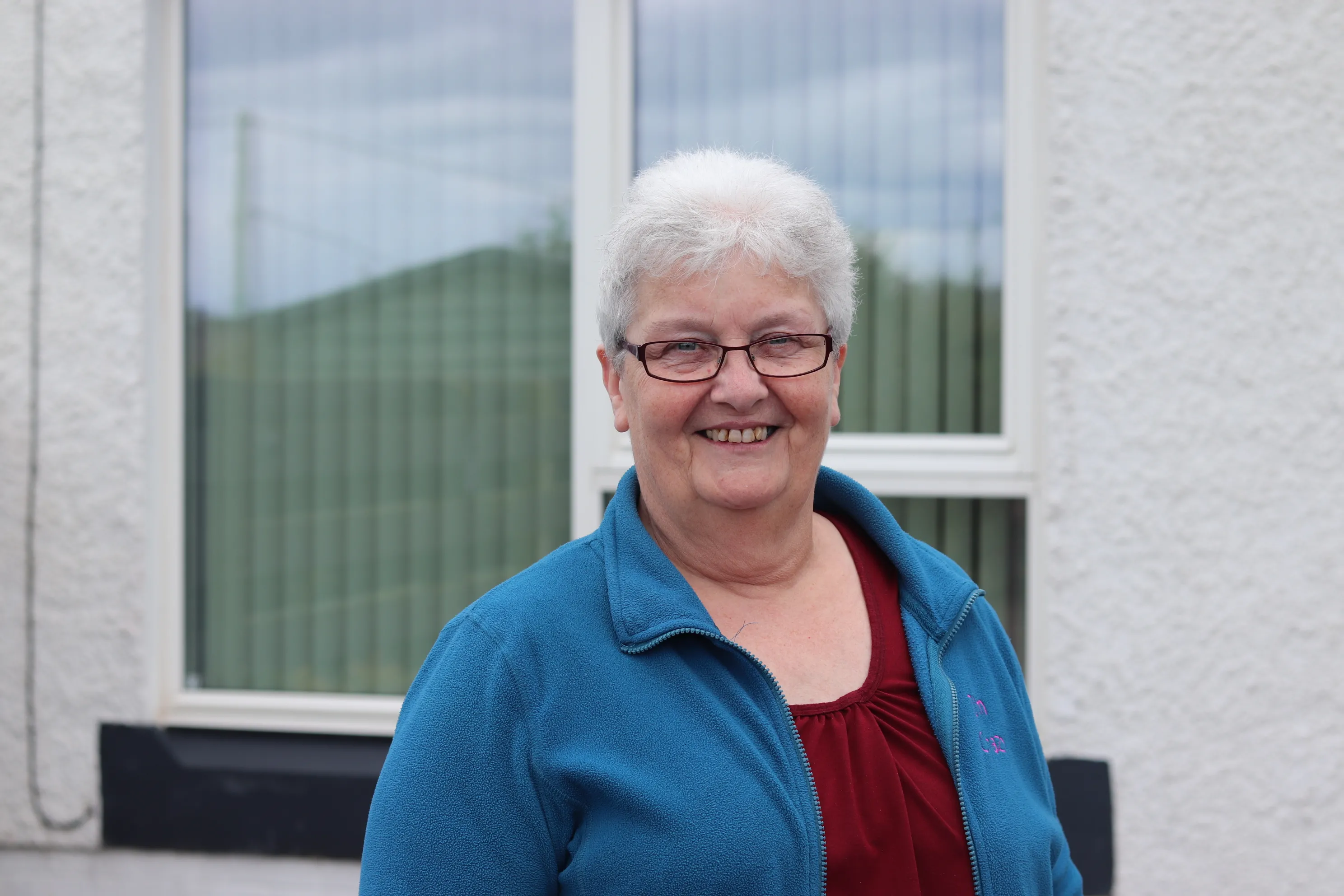 Hazel Farquar, in front of her home