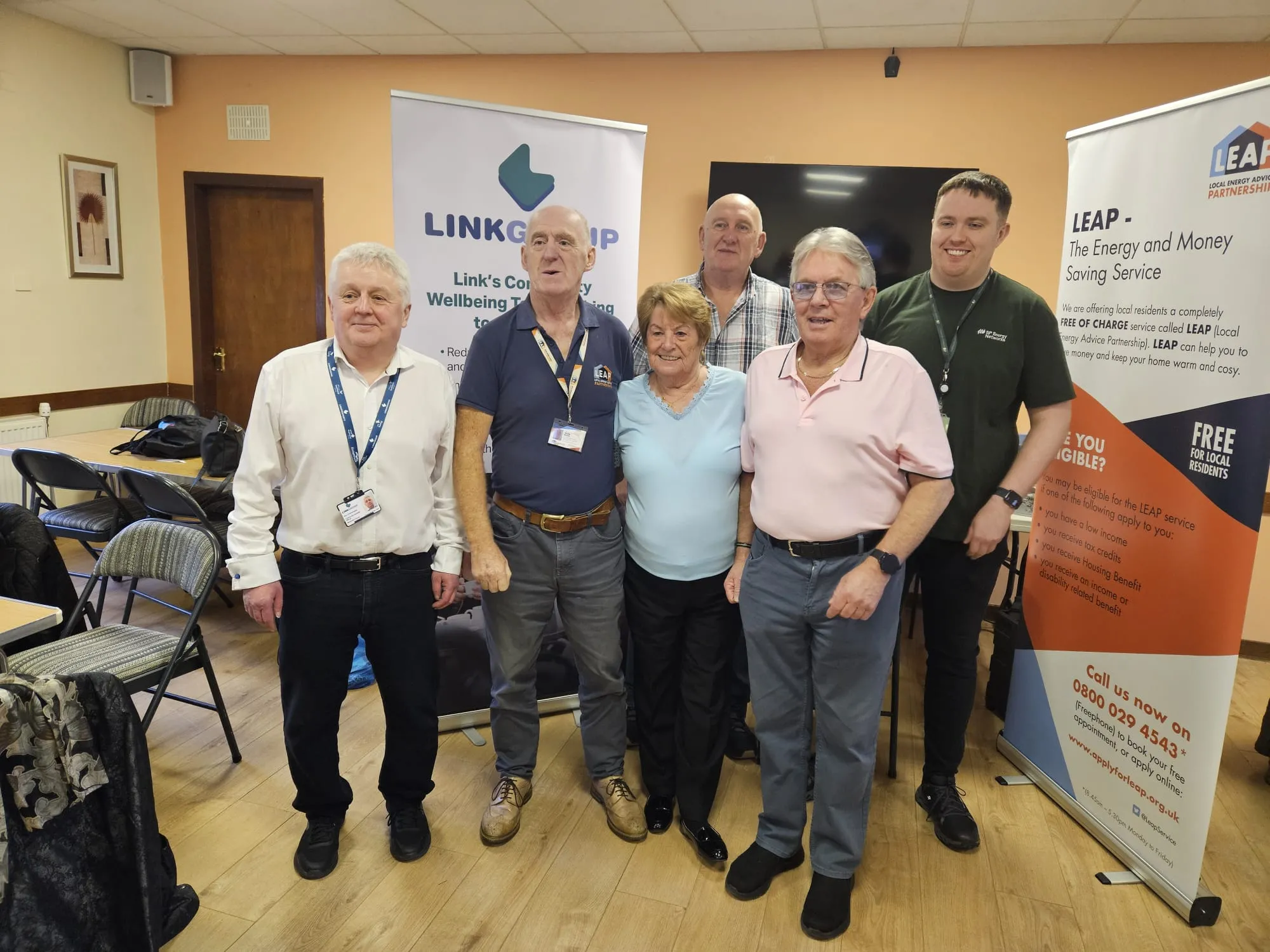 linkgroup staff in front of a banner