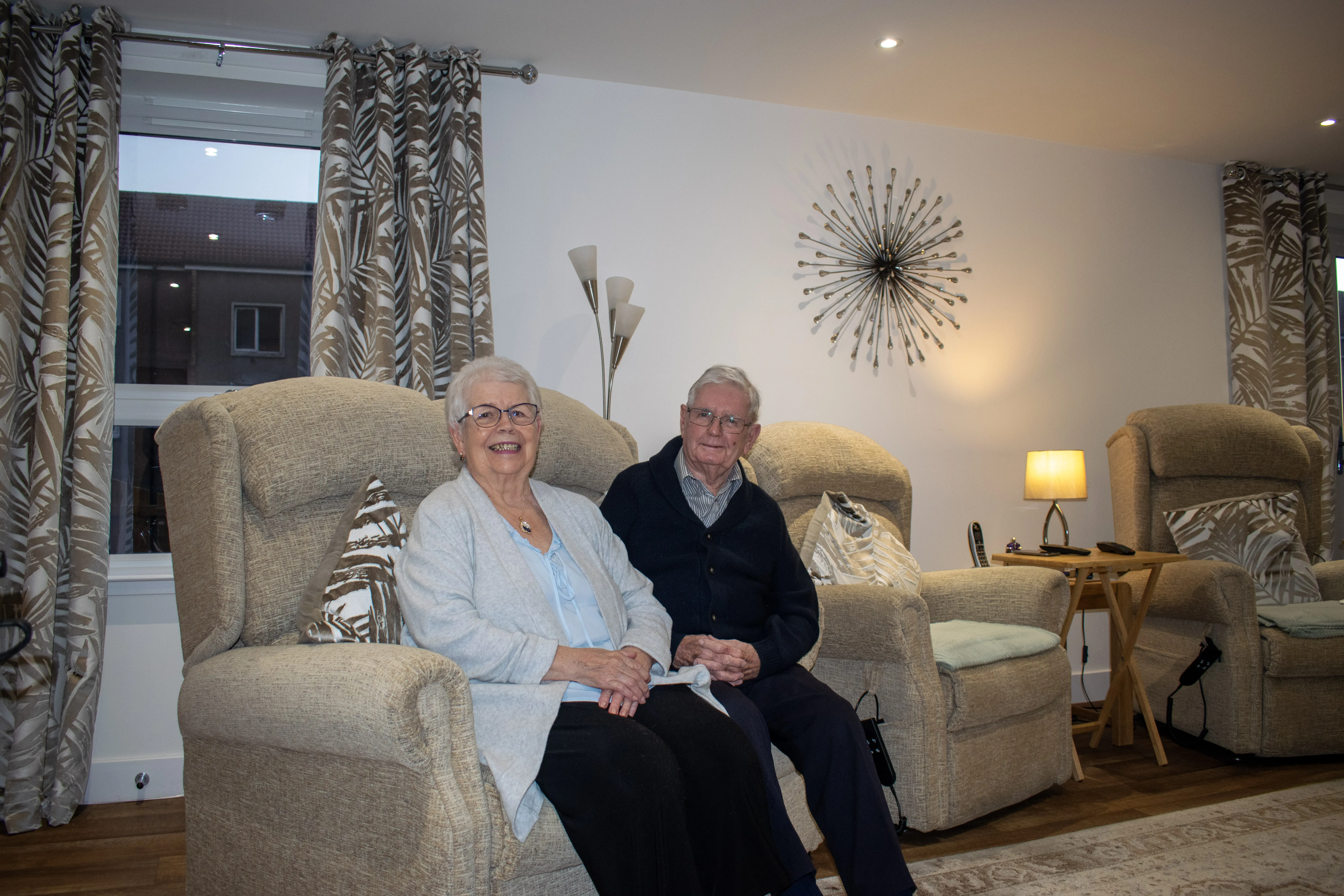 elderly Caucasian couple sitting on a couch