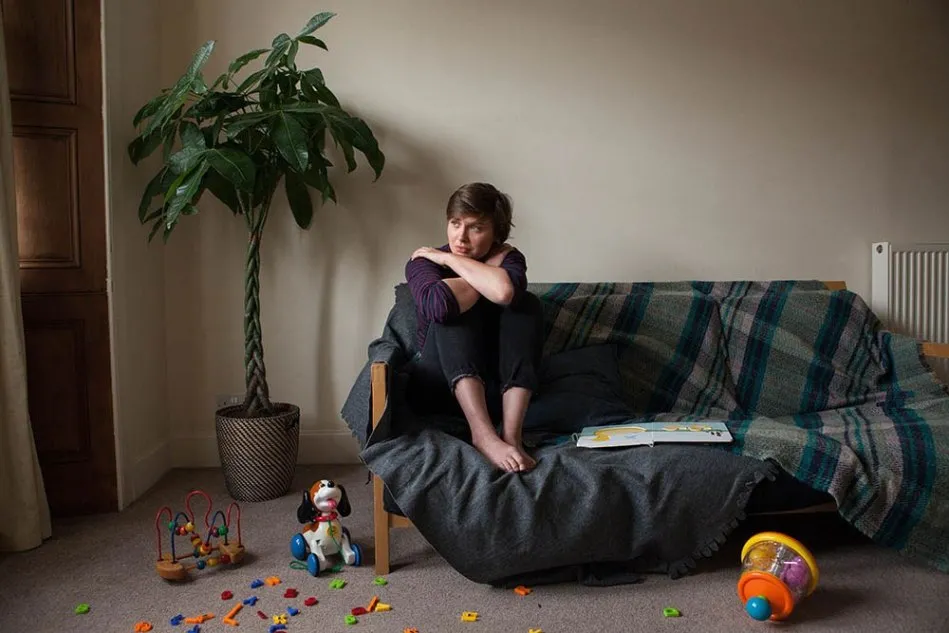 woman sitting on a couch looking concerned