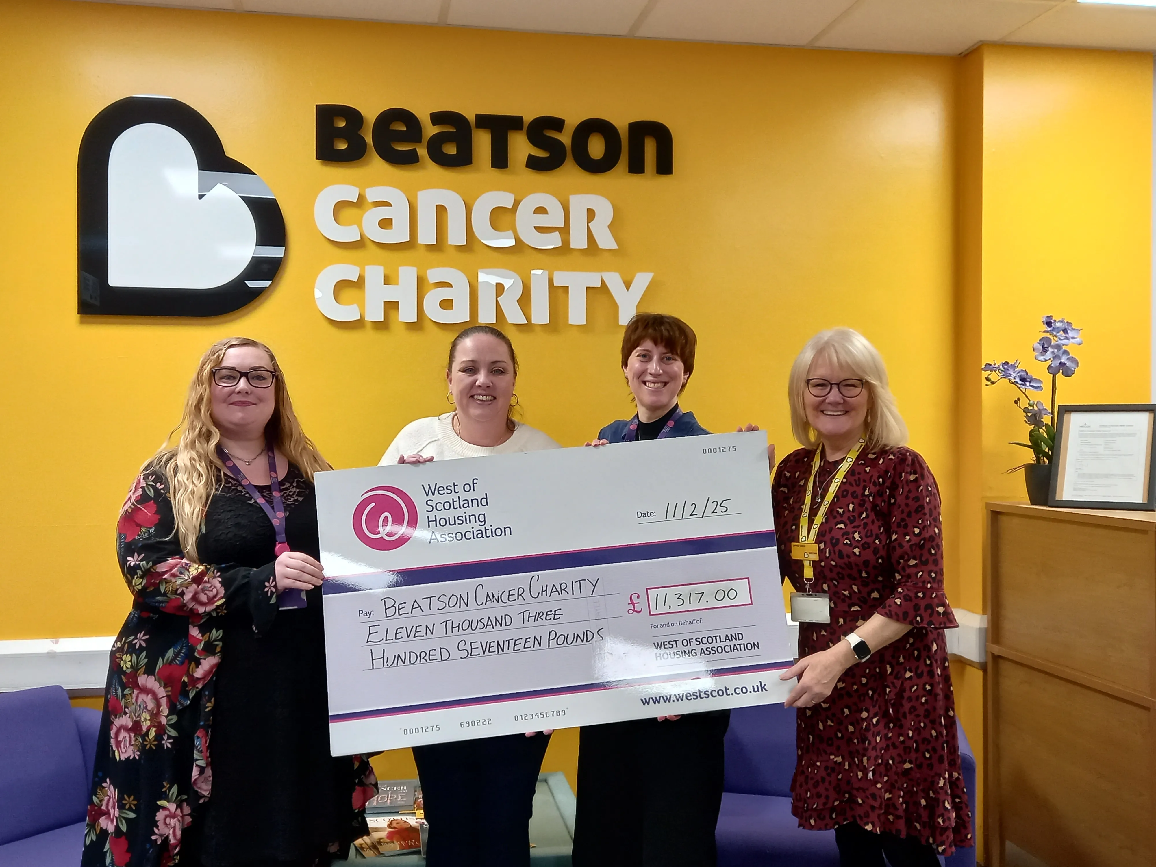 Staff presenting at large cheque at beatson