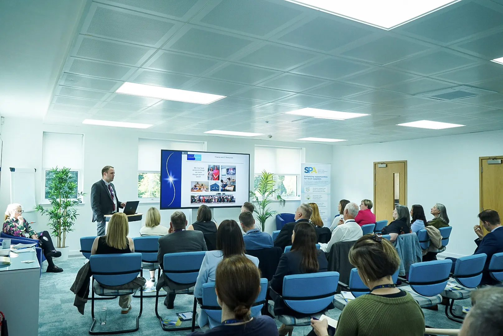 Group of people watching a presentation screen