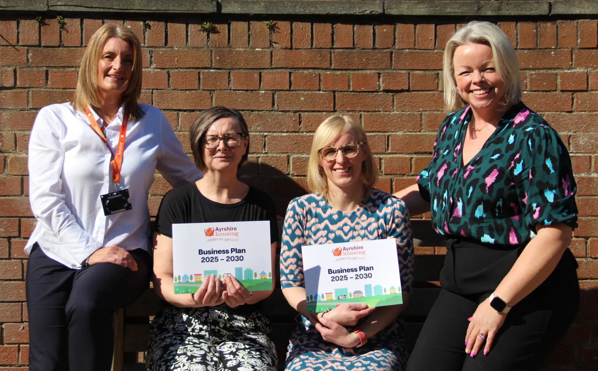 Ayrshire housing staff holding a business plan