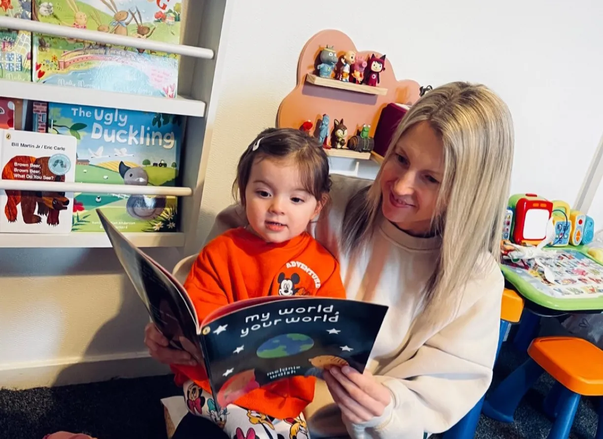 Woman and child reading book
