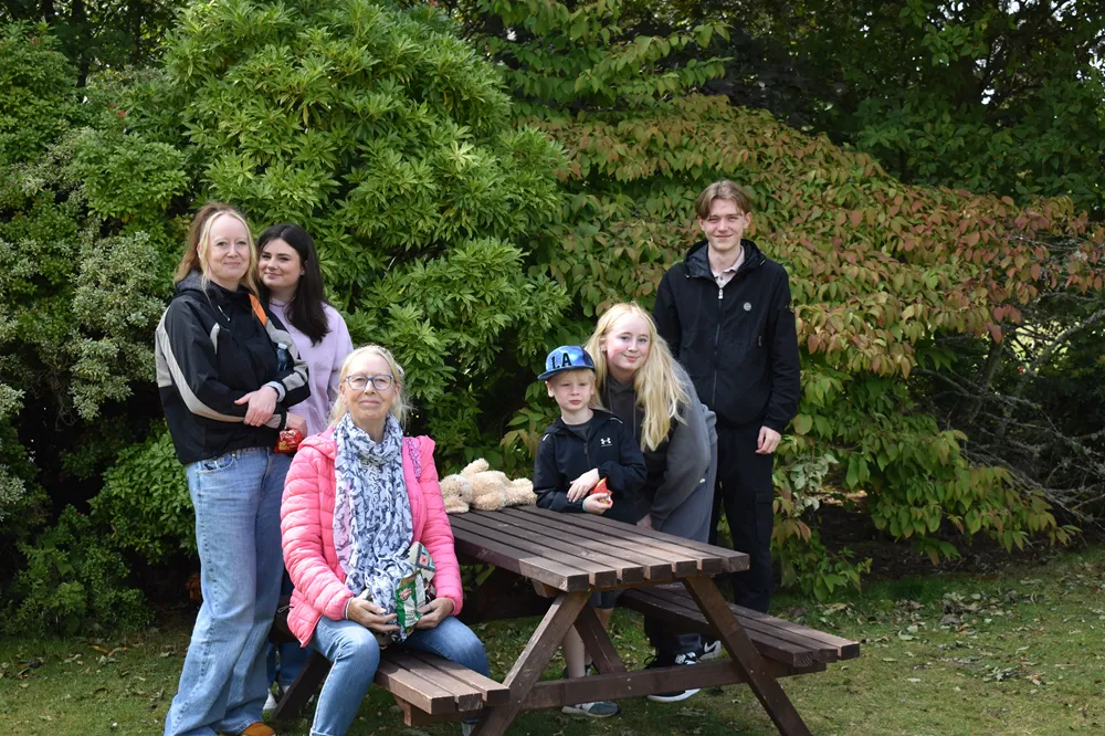 Mix of Kingdom Housing Association tenants at a picnic table