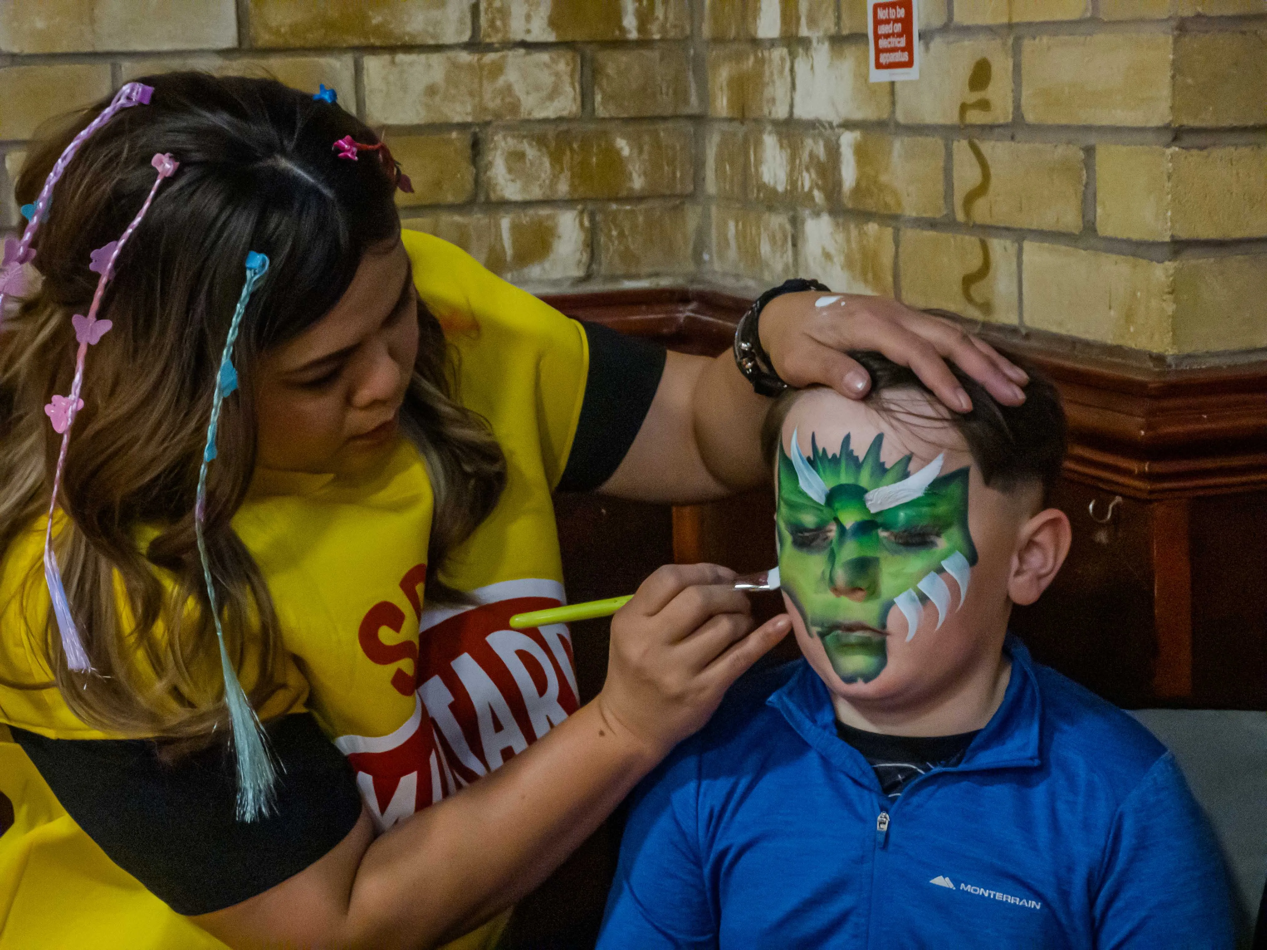 child having face painted