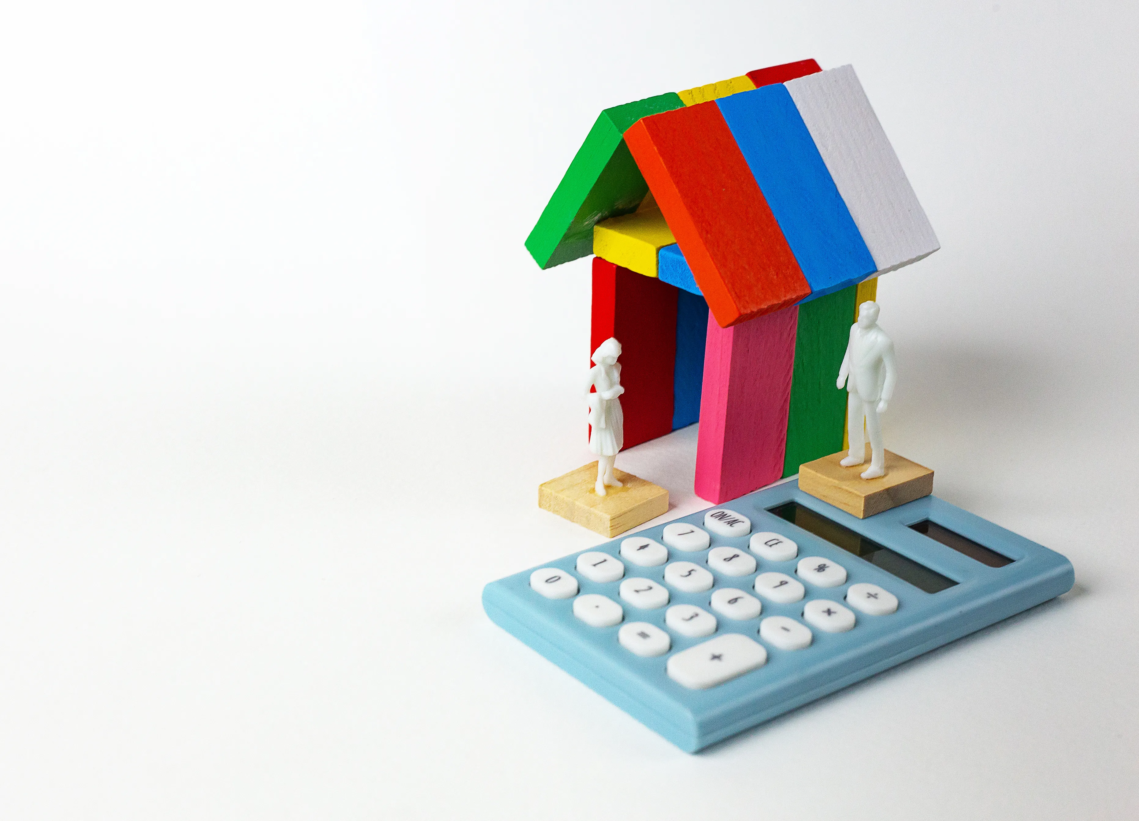 multi-colored-toy-blocks-with-figurines-calculator-white-background