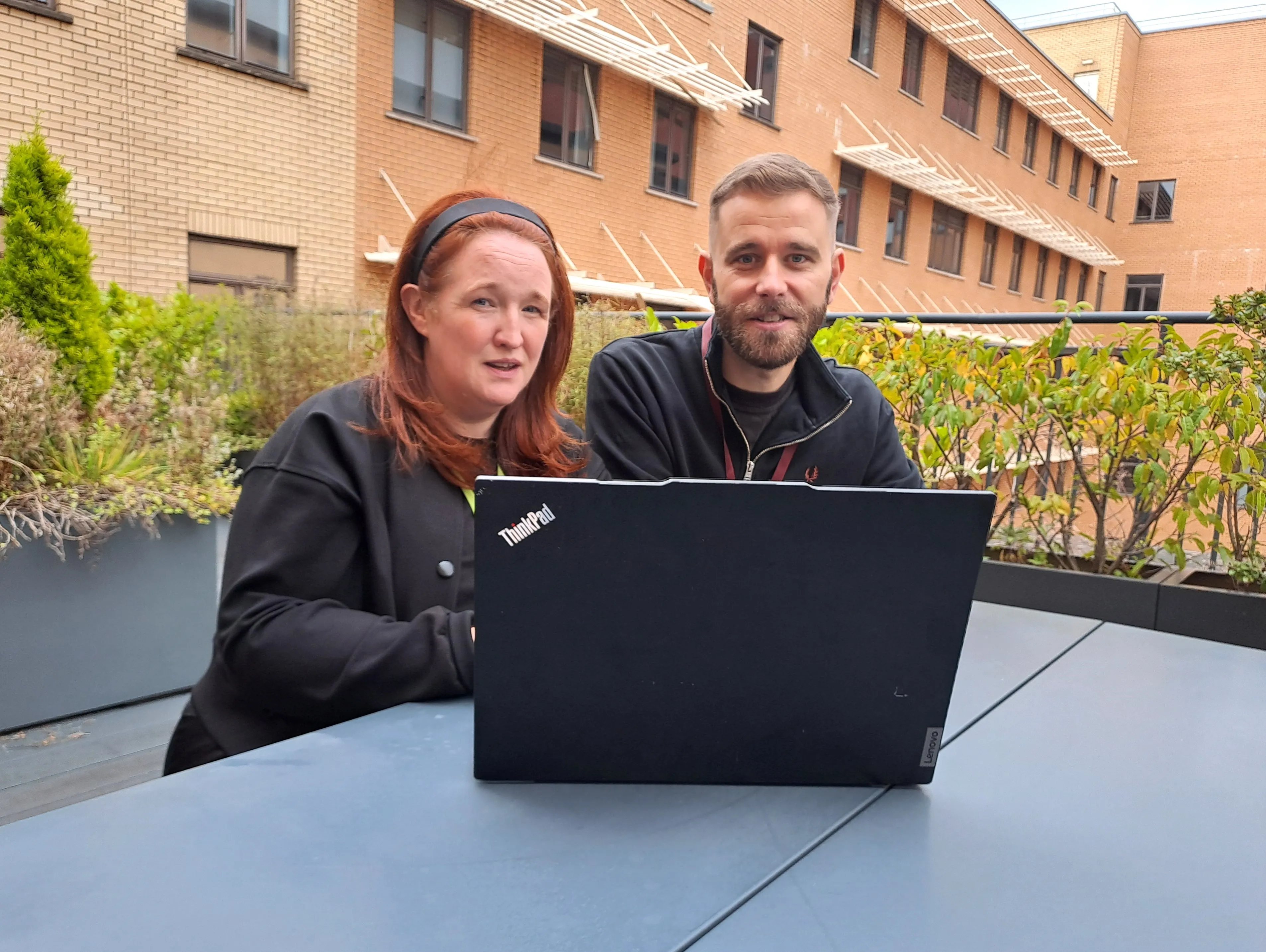 man and woman sitting at a laptop