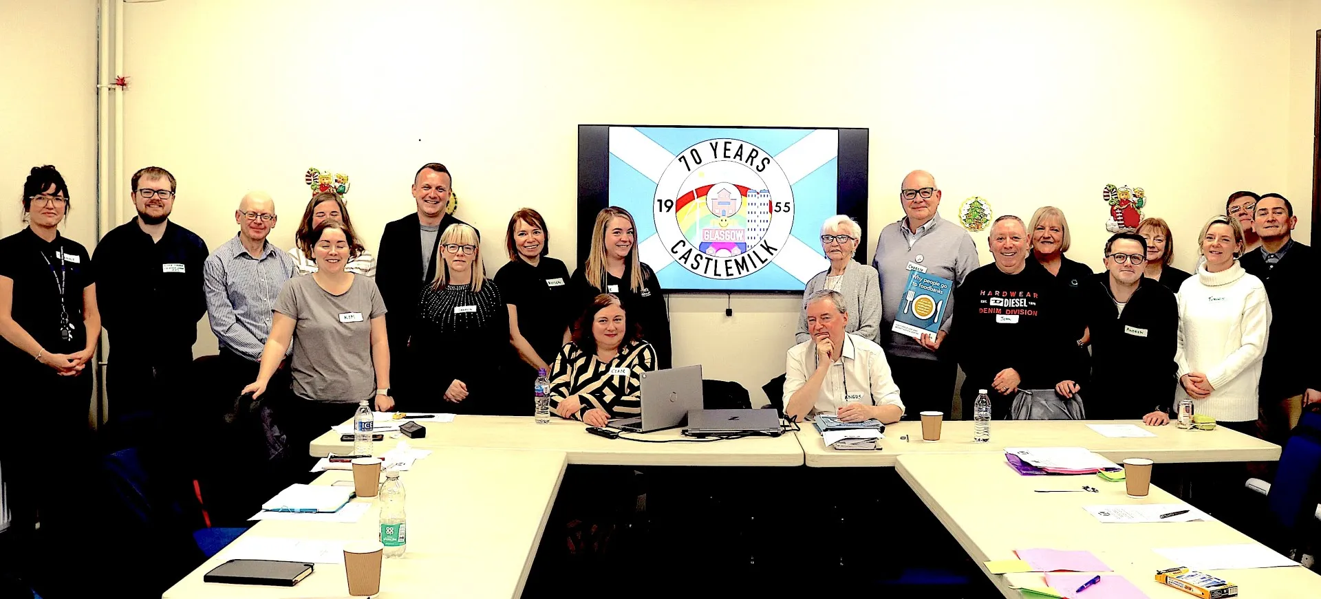 Castlemilk Human Rights board gathered around a table